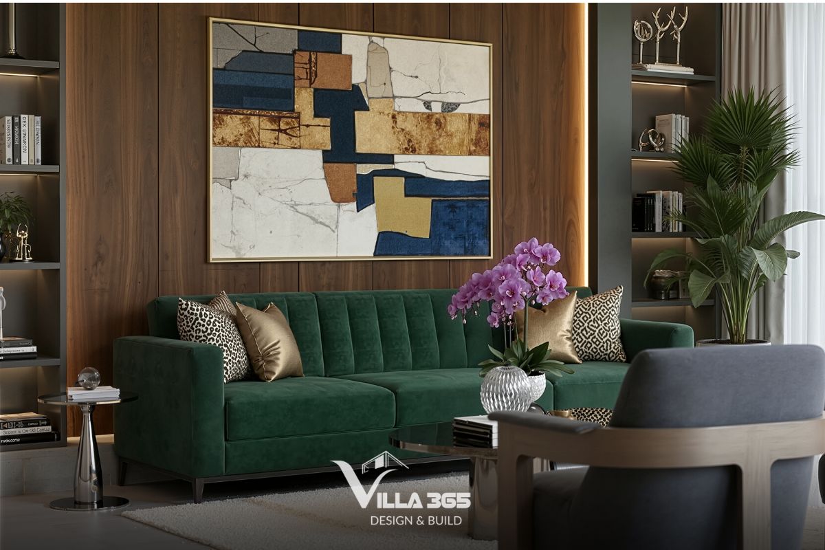 Điểm nhấn trung tâm là chiếc ghế sofa bọc vải nhung màu xanh lục bảo thiết kế tối giản với các đường chần múi dọc tinh tế ở phần tựa lưng 